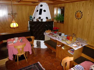 a dining room with a table and a vase on the wall at Garnì Conturina in Santa Cristina in Val Gardena