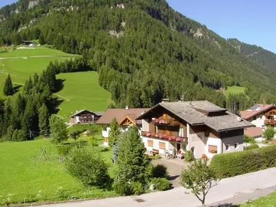 an aerial view of a house in a mountain at Garnì Conturina in Santa Cristina in Val Gardena