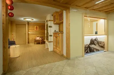 a living room with a large glass door to a room at Hotel Ronce in Ortisei