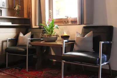 two chairs and a table with a plant on it at Villa Luise in Ortisei