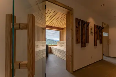a hallway with a door to a room with a window at Gasthof Videgg in Schenna