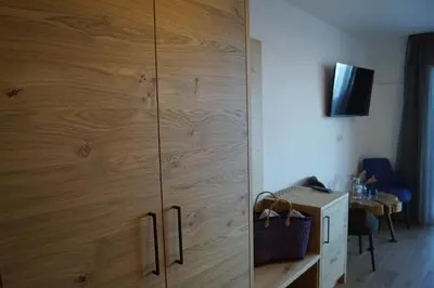 a large wooden cabinet in a room with a desk at Gasthof Videgg in Schenna