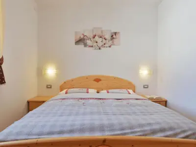 a bedroom with a bed and a window at Apartment Fabio Deluca by Interhome in Vigo di Fassa