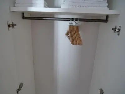a shelf in a bathroom with towels at Apartments Sabine K in Merano