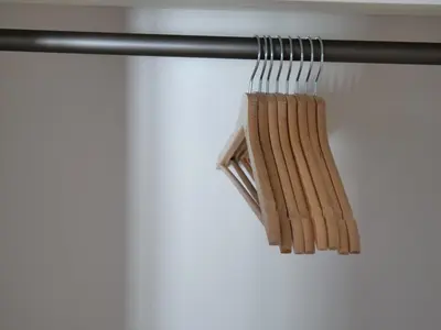 a bunch of wooden chopsticks hanging from a rail at Apartments Sabine K in Merano