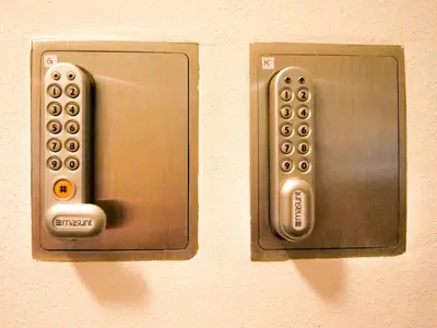two remote controls are attached to a wall at Apartments Sabine K in Merano