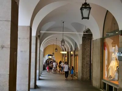 people walking down an arcade in a shopping mall at Apartments Sabine K in Merano