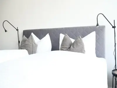 a bedroom with a white bed with pillows at Apartments Sabine K in Merano