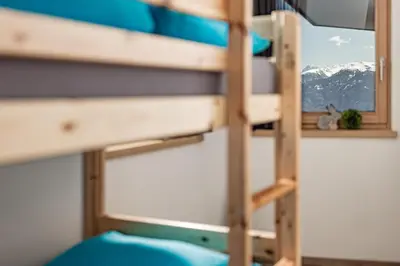 a bunk bed with a view of a mountain at Sweet Dolomiti Sonneck in Maranza