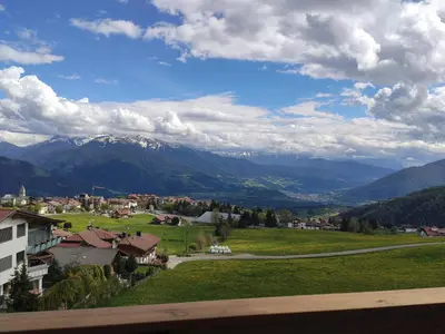 a view of a town with mountains in the background at Sweet Dolomiti Sonneck in Maranza
