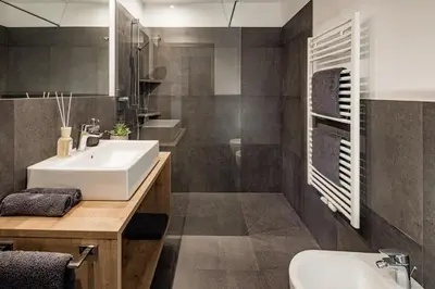 a bathroom with a sink and a mirror at Sweet Dolomiti Sonneck in Maranza