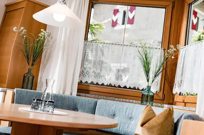 a dining room with a table and a window at Hotel Brunnhofer in Tirolo