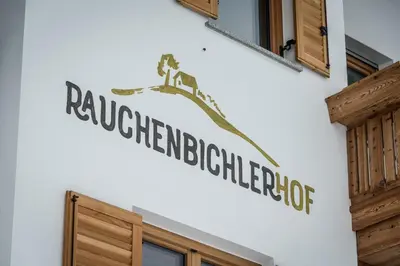 a sign on the side of a building at Rauchenbichlerhof in Brunico