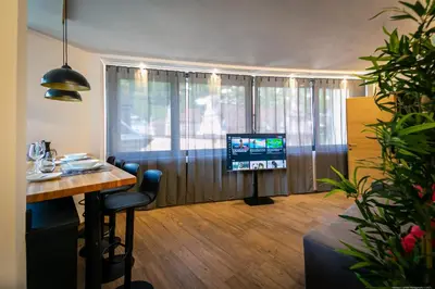 a living room with a table and a television at Apartment Mulino in Merano
