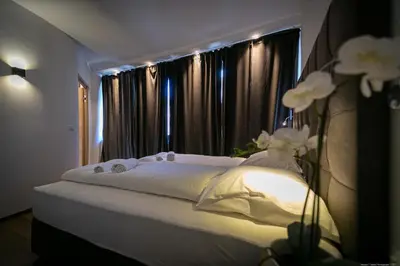 a white bed in a room with a window at Apartment Mulino in Merano