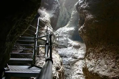 a staircase leading into a cave in a cliff at Viridis Hotel in Revò