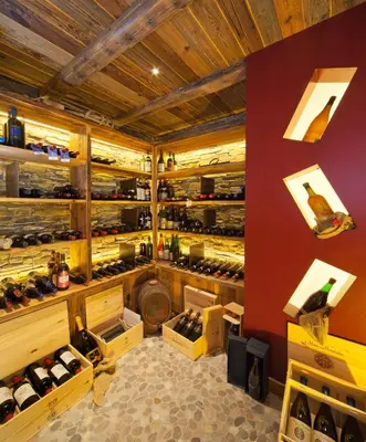a wine tasting room with a lot of wine bottles at Viridis Hotel in Revò
