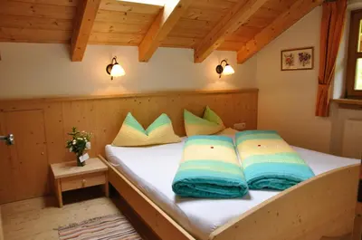 a bedroom with a bed with blue and yellow pillows at Maurerhof in Racines