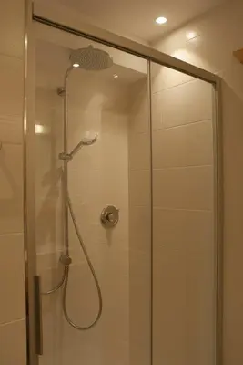 a shower with a glass door in a bathroom at Maurerhof in Racines