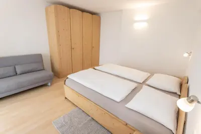a small room with a bed and a couch at Residence Haus Heinrich in Montagna