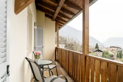 a balcony with a table and chairs and a view at Residence Haus Heinrich in Montagna