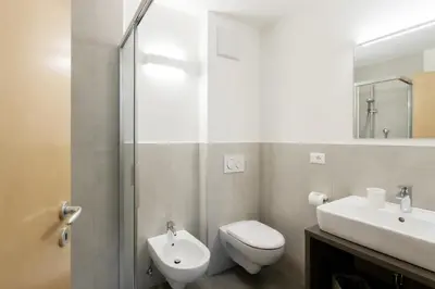 a bathroom with a toilet and a sink and a shower at Residence Haus Heinrich in Montagna