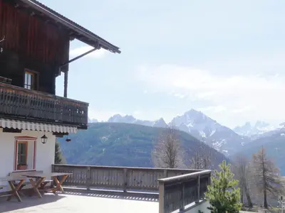a balcony of a house with a view of mountains at Lienharterhof in Monguelfo