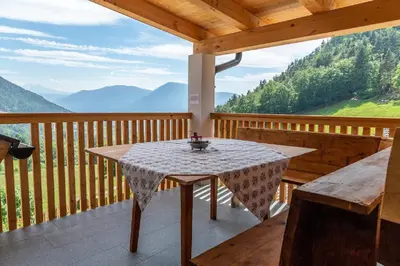 a table on a balcony with a view of mountains at Moarhof in Oberbozen in Soprabolzano