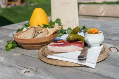a table with a plate of food and a bowl of bread at Moarhof in Oberbozen in Soprabolzano