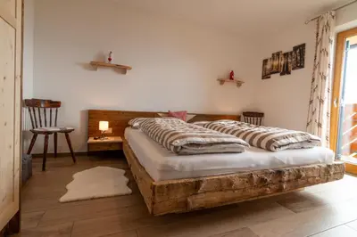 a bedroom with a wooden bed with pillows on it at Moarhof in Oberbozen in Soprabolzano