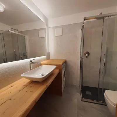a bathroom with a sink and a shower at Casa Maddalena in Canazei