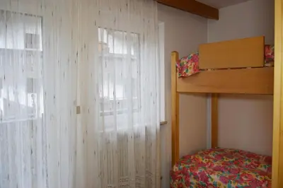a bedroom with a bunk bed and a window at Casa Maddalena in Canazei