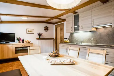 a kitchen with a table with a bowl of fruit on it at Cesa Paula in Selva di Val Gardena