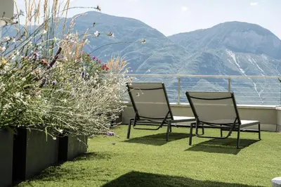 two chairs on a balcony with a view of a mountain at Haus Sauvignon in Cortaccia