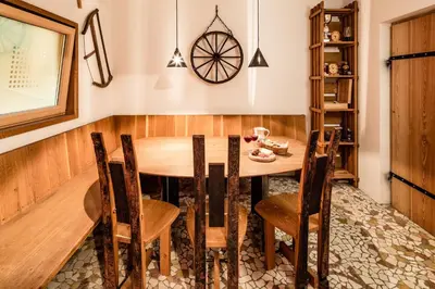 a dining room with a wooden table and chairs at Haus Sauvignon in Cortaccia