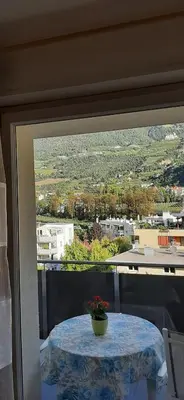 a table with a vase on top of a balcony at Merano Panoramablick ruhig gelegen in Merano