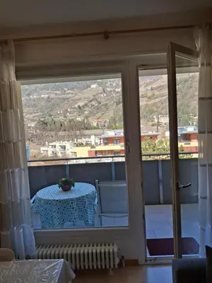 a view from the balcony of a room with a table at Merano Panoramablick ruhig gelegen in Merano