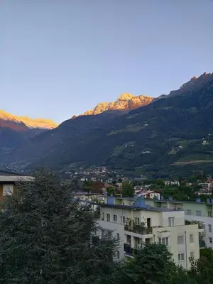 a view of a city with mountains in the background at Merano Panoramablick ruhig gelegen in Merano