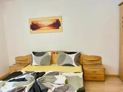 a bedroom with a bed and a picture on the wall at Merano Panoramablick ruhig gelegen in Merano