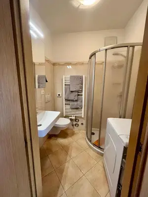 a bathroom with a toilet and a sink and a shower at Merano Panoramablick ruhig gelegen in Merano