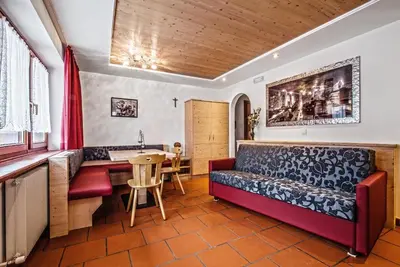 a living room with a couch and a table at Residence A Val in San Cassiano