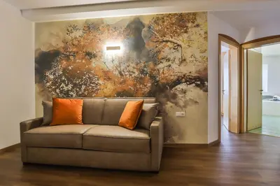a couch in a room with a painting on the wall at Residence Kronenwirt in Parcines