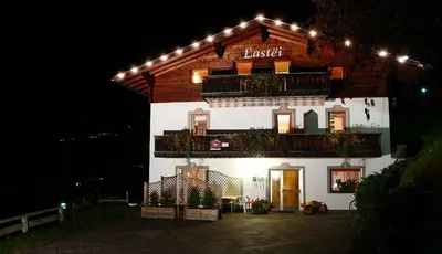 a building with lights on top of it at night at Residence Lastei in Ortisei