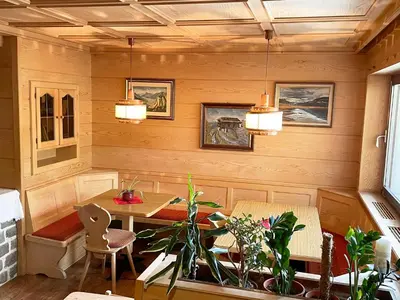 a dining room with a table and chairs and lights at Residence Lastei in Ortisei