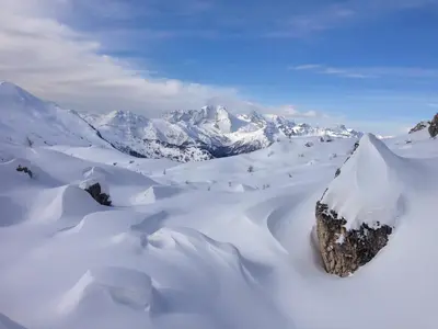 a snowy mountain range with a large rock in the snow at Apartment Cesa Collina Family Retreat in Ortisei