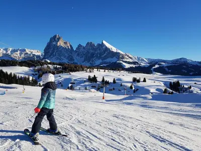 a young child is skiing down a snow covered mountain at Apartment Cesa Collina Family Retreat in Ortisei