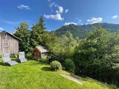 a yard with two chairs and a barn at Apartment Cesa Collina Family Retreat in Ortisei