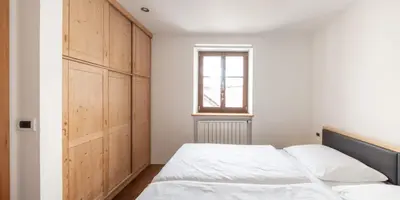 a bedroom with a bed and a window at Apartment Cesa Collina Family Retreat in Ortisei