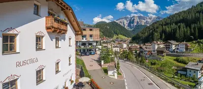 a view of a small town in the mountains at Apartments Rusctlea in Selva di Val Gardena
