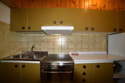 a kitchen with a sink and a stove at Il cirmolo in Vigo di Fassa